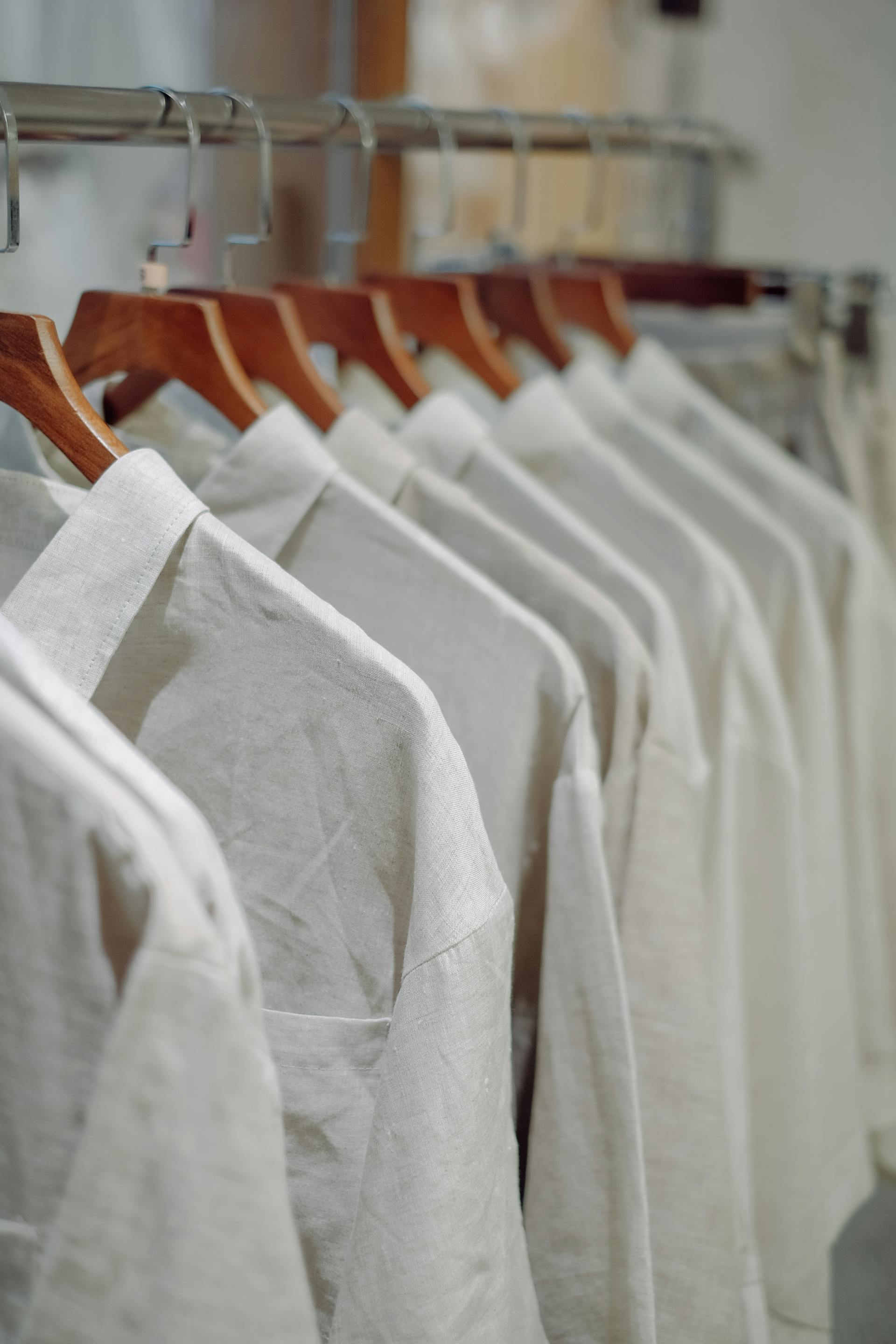 White woven blouses on wooden hangers
